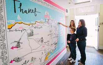 Visitors exploring the map of Thanet at the Visitor Information Centre, image credit Thanet District Council