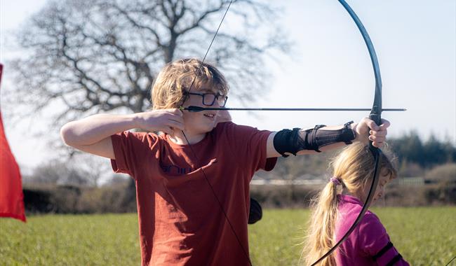 A boy enjoying the Easter Archery Tournament with New Forest Activities