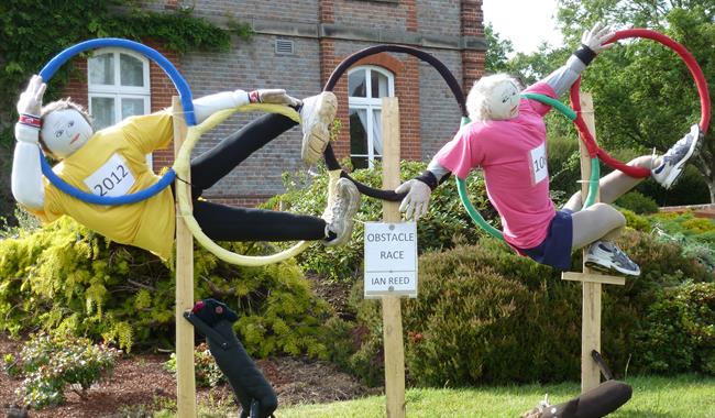 Scarecrows in Olympic hoops at Battle Scarecrow Festival