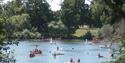 Messing about in boats on Mote Park boating lake in the summer