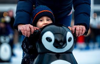 Child with a penguin-shaped skate aid at Ice Skate Portsmouth - credit Ice Skate Portsmouth and Vernon Nash