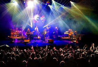 A performance of Eclipse: The Pink Floyd experience on stage with lights and lasers. There is also an audience.