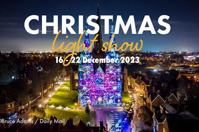Image shows Lichfield Cathedral with spectacular projections onto its facade and beautiful lighting all around, with the dates of the Christmas Light