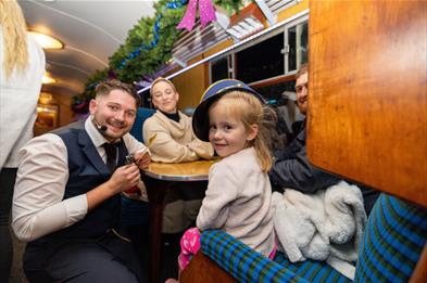Image shows a family enjoying a festive day out on The Polar Express