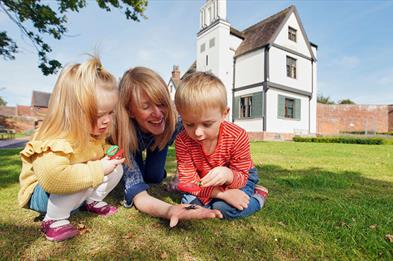 Family exploring the grounds of Boscobel House, South Staffordshire.