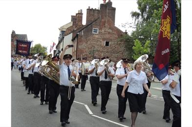 image of a Brass Band walking in the Leek Club Day Procession