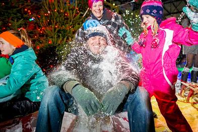 A family pelts Dad with snowballs at the Snowdome, Staffordshire