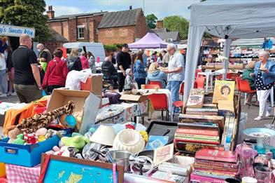 Visitors browse stalls full of bric-a-brac at Penkridge Market, Staffordshire