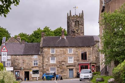 Longnor Village high street, shops fronts and the church in the background