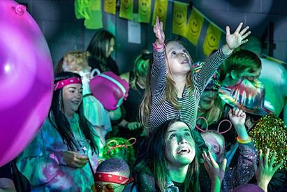 A girl on her mum's shoulders enjoys the show at the Big Fish Little Fish Family Rave, in Stafford, Staffordshire