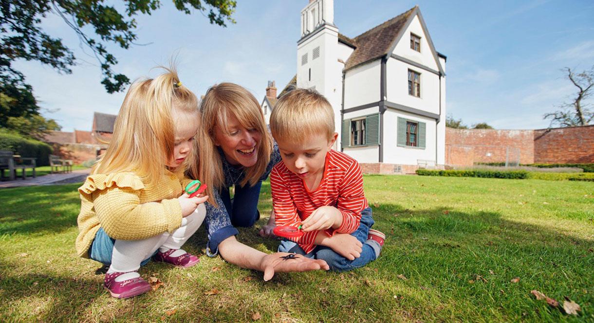 Family exploring the grounds of Boscobel House, South Staffordshire.