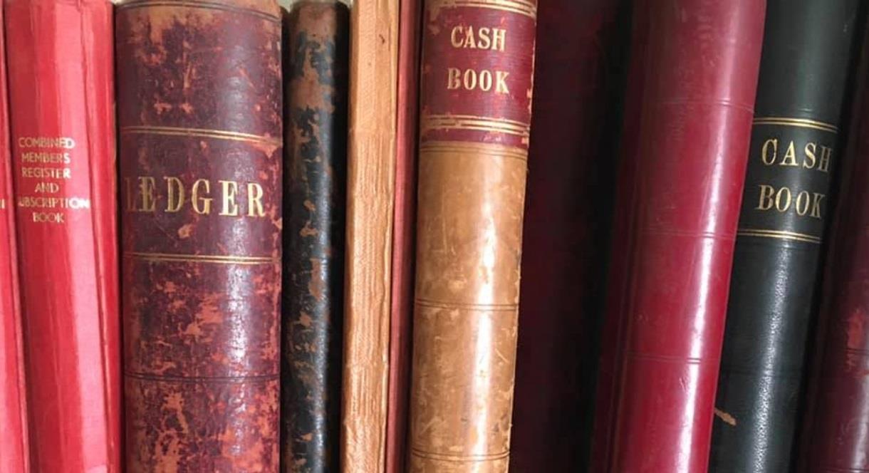 image of Cash and Ledger books on a shelf