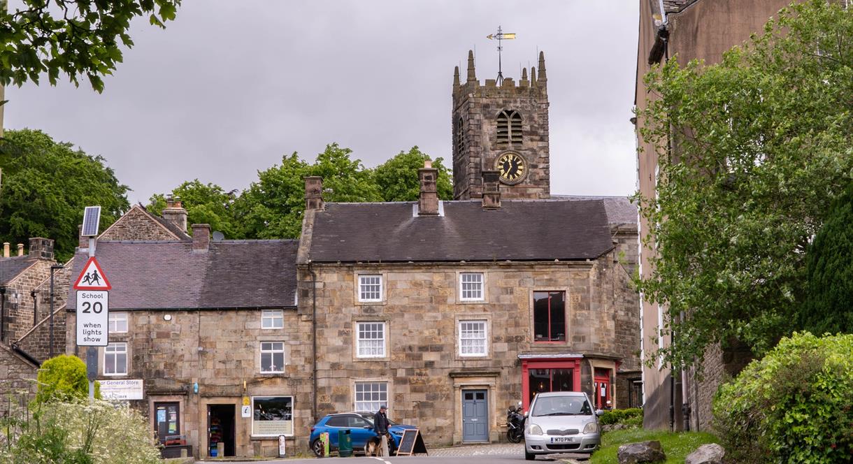 Longnor Village high street, shops fronts and the church in the background