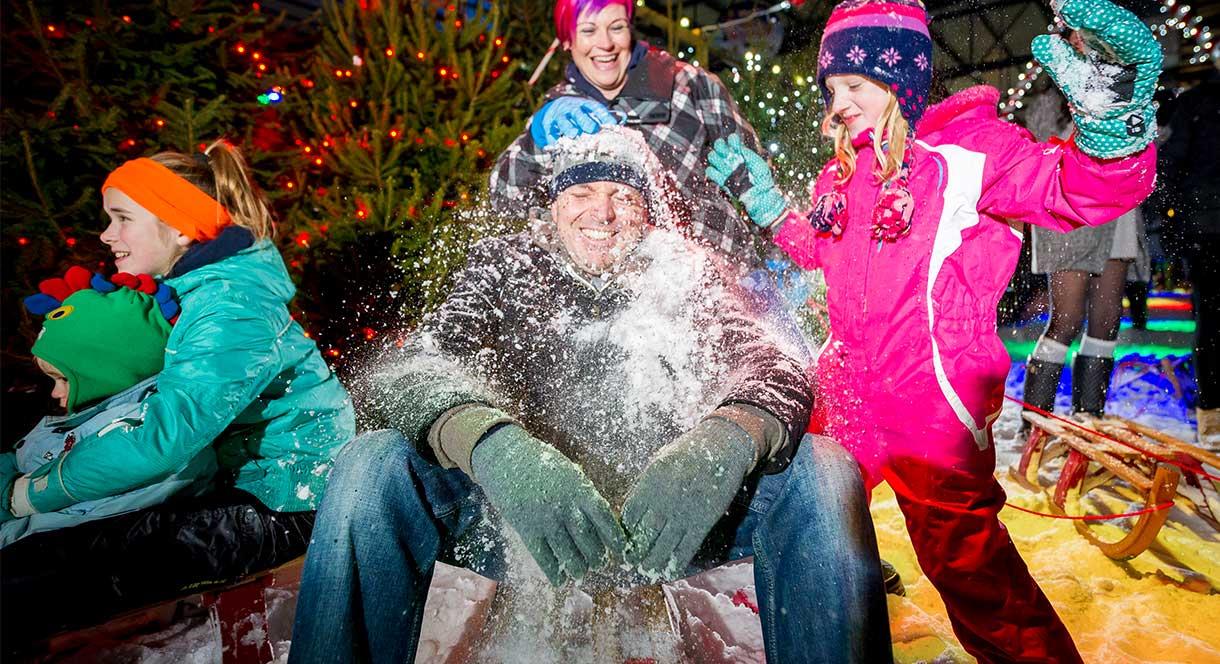 A family pelts Dad with snowballs at the Snowdome, Staffordshire