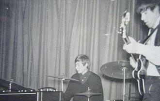 black and white photo of a band playing in the 1960s