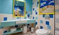 Bathrooms are well-equipped containing baths with showers over and extra features like children's toilet seats and steps.
