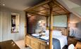 Image shows a four poster bed in one of the rooms at The Moat House