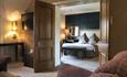 Image shows The Honeymoon Suite at The Moat House, looking through the double doors into the bedroom from the lounge
