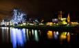 View across the lake at night with the Moat House Hotel illuminated