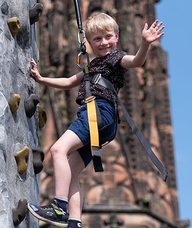 Boy on climbing wall at Lichfield Cathedral