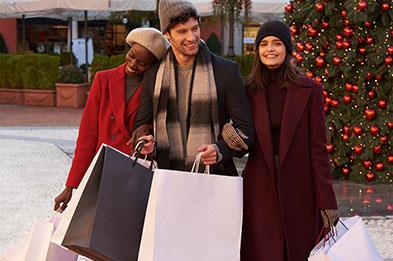 Group of friends Christmas shopping at McArthurGlen Designer Outlet West Midlands