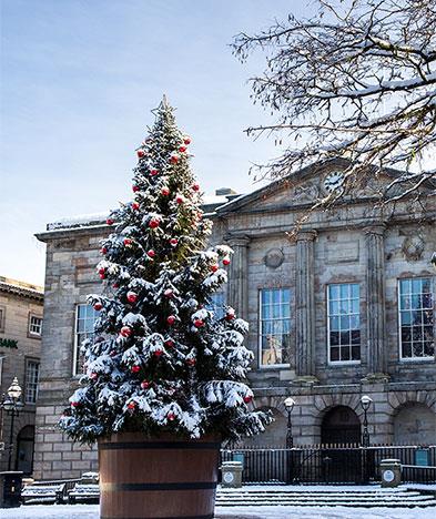 Christmas tree covered in snow at the Market Square in Stafford