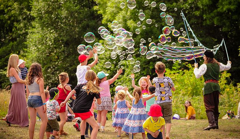 kids enjoying giant bubbles in Stafford Castle grounds