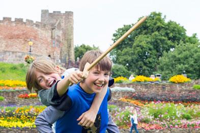 Boys role playing knights in front of Tamworth Castle