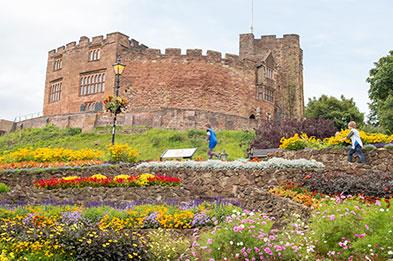 Tamworth Castle, Staffordshire with floral displays in the foreground.