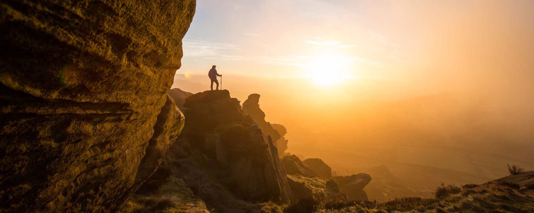 A lone walker atop the Roaches rocky outcrop, in the Peak District, near Leek, Staffordshire. Click to see more activities.