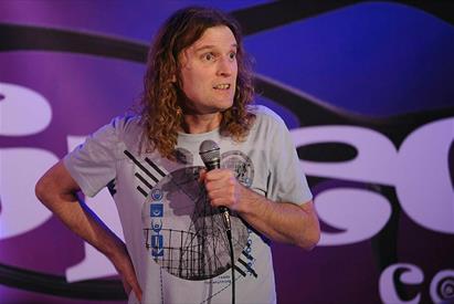 A comedian performs on stage