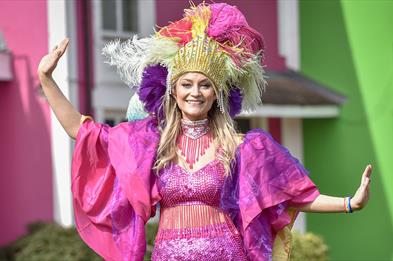 Colourfully dressed dancer at Alton Towers Mardi Gras