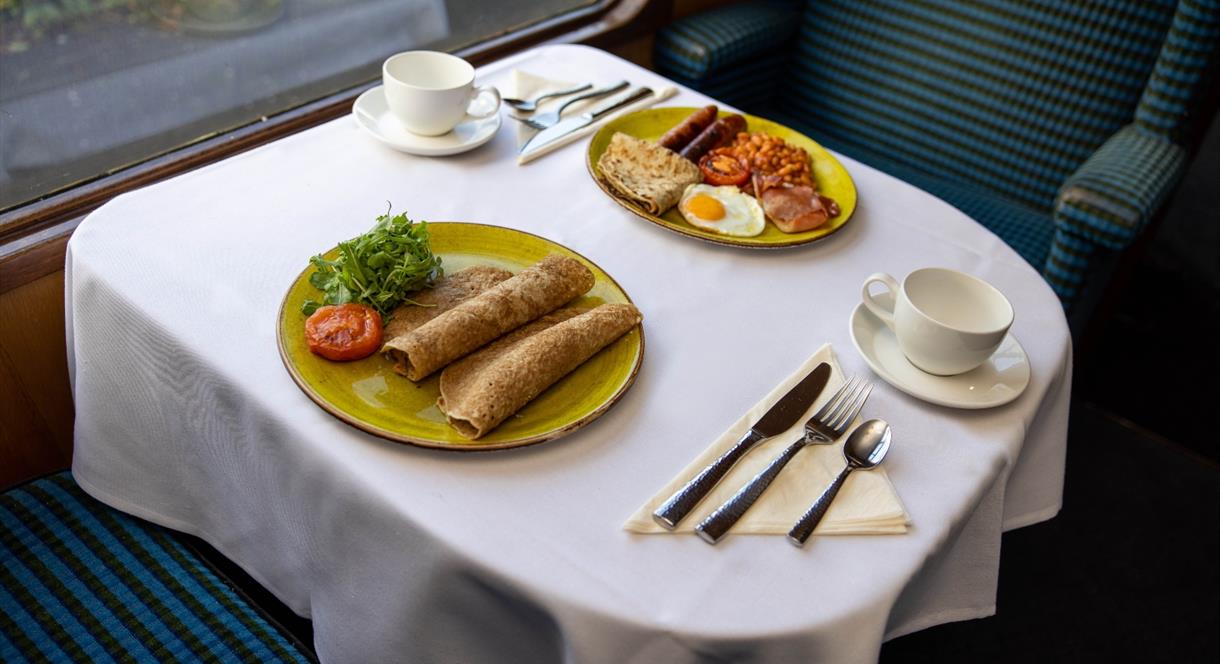 A hearty breakfast awaits you on the beautiful steam train carriages of Churnet Valley Railway, Staffordshire