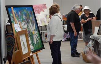 Visitors take a closer look at the artistic creations on show at The Brampton Museum, Staffordshire