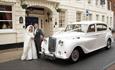 Classic Car with Bride and Groom outside the George Hotel.