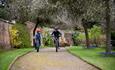 Image shows two boys riding their bikes through the grounds of Weston Park