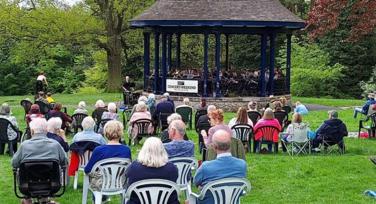 image of a concert and audience at a bandstand