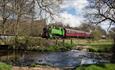A train passes the ford at Churnet Valley Railway, Staffordshire