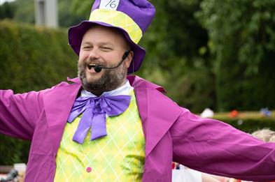 Image shows a man dressed as a character from Alice in Wonderland