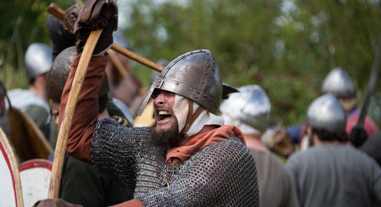 Image shows a man wearing chain mail at a re-enactment
