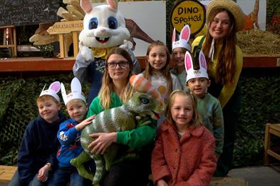 Image shows a group of children and staff from Lower Drayton Farm, including an Easter bunny and a baby dinosaur!