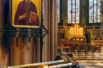 Image shows the interior of Lichfield Cathedral, with the historic stained glass Herkenrode windows in the background