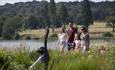 Family walking alongside the lake at the Trentham Estate