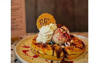 image of a waffle with ice cream and sprinkles