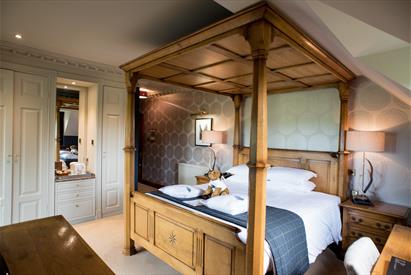Image shows a four poster bed in one of the rooms at The Moat House