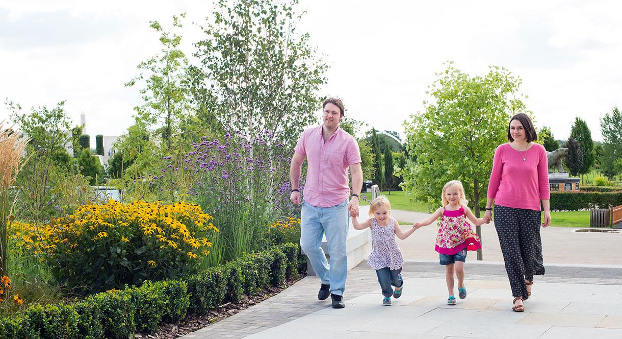 Family with young children walking in National Memorial Arboretum grounds, Staffordshire