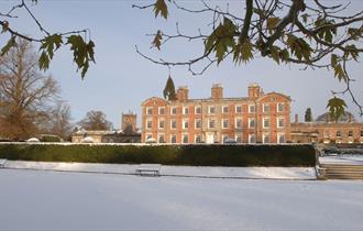 The house at Weston Park surrounded by snowy landscape