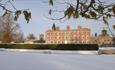 The house at Weston Park surrounded by snowy landscape