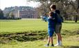 Image shows two boys looking into the distance at Weston Park on a sunny day
