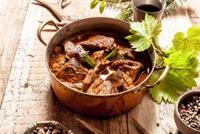 Image shows a delicious-looking game dish in a saucepan